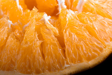 internal texture of a juicy ripe orange macro on a black background