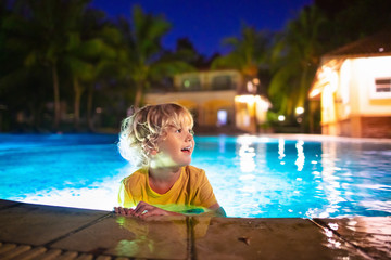 Kids in swimming pool at night