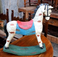 evocative image of a wooden toy rocking horse from the 50s at a vintage market
