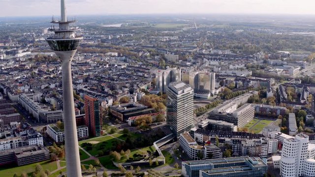 Drone shot of the Rhinetower in Düsseldorf. The video shows the Rhine Tower and the city gate of the Düsseldorf Media Harbour.