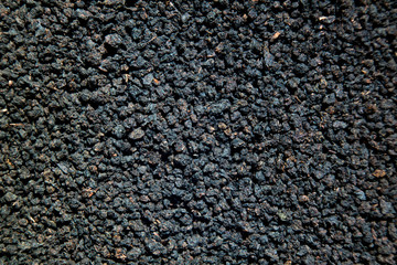 Granulated black tea close up background like earth