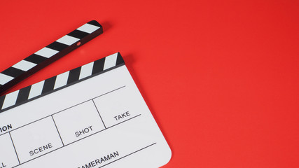 White Clapperboard or movie slate on red background. it use in video production and film industry .