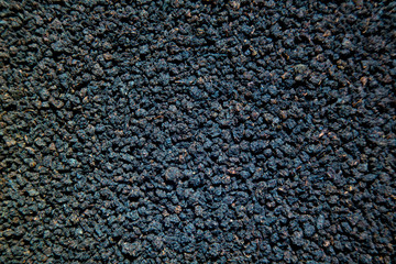 Granulated black tea close up background like earth
