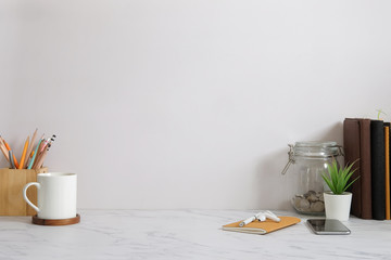 Mockup workspace desk and copy space books,plant and coffee on wood desk.