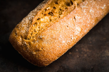 Freshly baked rustic bread on the rustic background