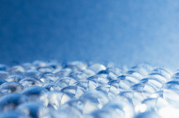Abstract microbiology background - blue glass nucleuses surface with glowing particles inside, copy...