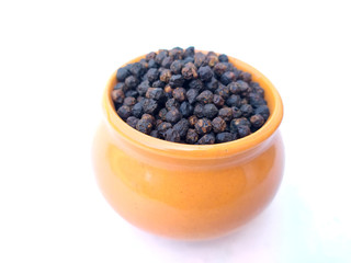 Black pepper peas put in a blue bowl isolated on white background