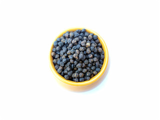 Black pepper peas put in a blue bowl isolated on white background