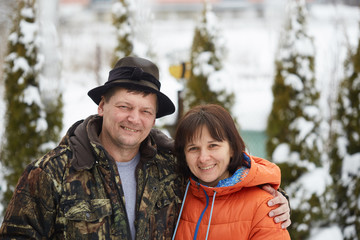 Portrait of a young couple having a rest in winter park.