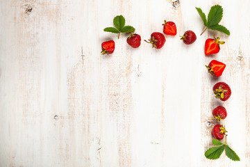 Ripe strawberries on a wooden table.