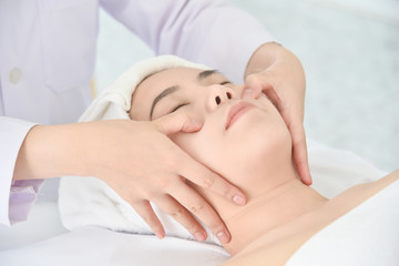 Obraz na płótnie Canvas Therapist doing Tui na massage at her patient face ,Chinese alternative medicine.
