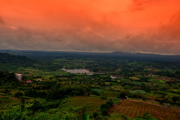 Obraz premium Abstract background of blurred morning nature,green rice fields and surrounded mountains and colorful sky