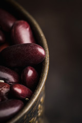 Purple beans on the rustic background. Selective focus. Shallow depth of field.