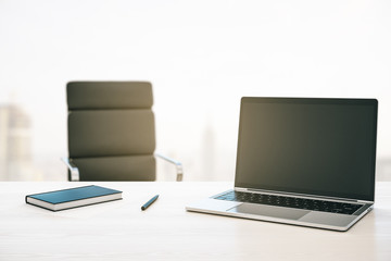 Morning desktop with laptop, armchair and a window with a city view. Mockup. 3D Rendering