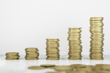 Golden growing stacks of coins. Investing and accumulating concept. 3D Rendering