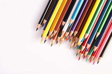 Colored pencils lie in a row