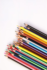 Colored pencils lie in a row