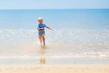 Kids playing on beach. Children play at sea.