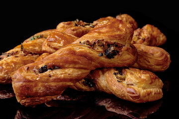  Homemade cakes with cheese and vegetables. Black background. Close-up.