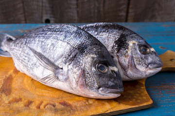 Rustic style. Fish food. Herring fish on an old blue wooden background.