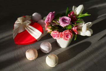 Bouquet of flowers, box shaped hear and marshmallow  on the table. Valentine 's Day, Mother 's Day