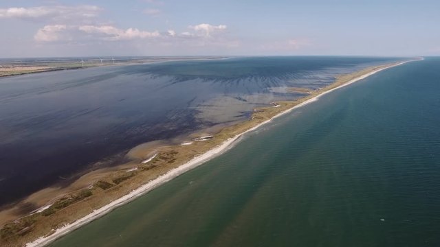 Aerial shot of a fabulous chalkstone sandspit on the Black Sea in summer.