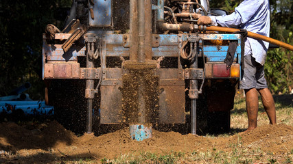 Fototapeta na wymiar ground drilling water machine on old truck drilling in the ground for water