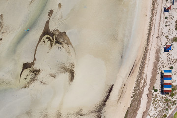 Unidentifiable paddleboarders prepare to go into the sea on Whyalla beach in South Australia