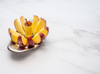 Close up of red apple cut in to segments using a specific apple chopper tool with copy space
