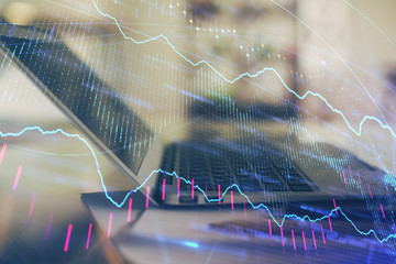 Forex graph hologram on table with computer background. Double exposure. Concept of financial...