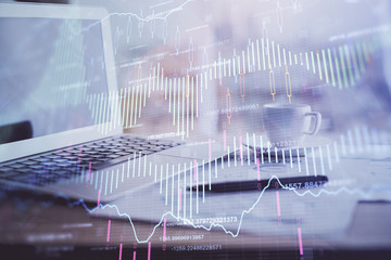 Forex graph hologram on table with computer background. Double exposure. Concept of financial markets.