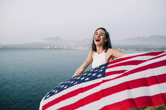 Beautiful woman celebrating holding the American falg