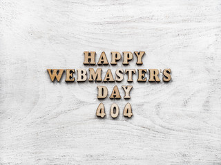 Webmaster Day greeting card. Isolated background, close-up, view from above, wooden surface. Congratulations for relatives, friends and colleagues