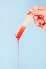 depilation and beauty concept - sugar paste or wax honey for hair removing with wooden waxing...