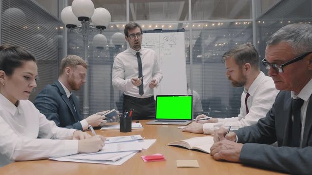 Colleagues and clients talking about strategy with laptop green screen. Group of business people work discuss communicate at meeting board room
