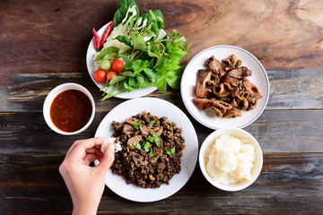 Northern Thai food, spicy minced pork salad (Larb Moo Kua) eating with sticky rice, grilled...
