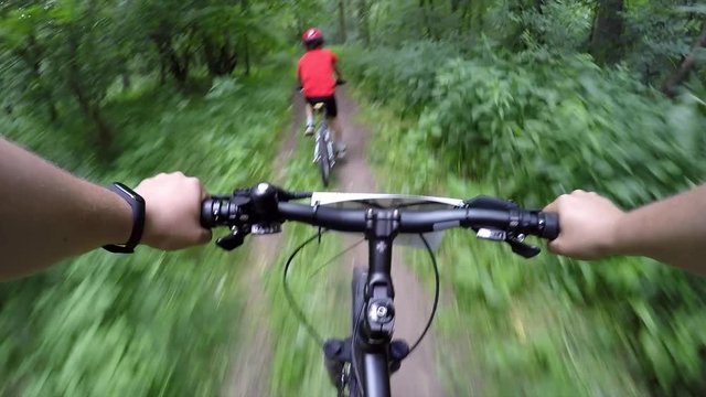 Father and son take part in a bicycle race in the forest