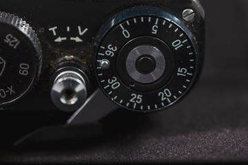 Detail of an old camera - adjuster, closeup. Retro camera in scratches and dust from a private collection.