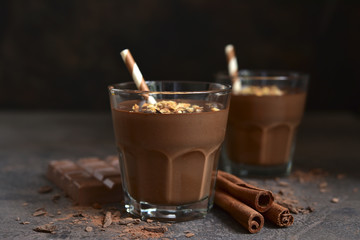 Homemade delicious chocolate banana smoothie with cinnamon and granola.