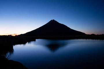 Mt Taranaki reflected in the Pouakai tarn at dawn