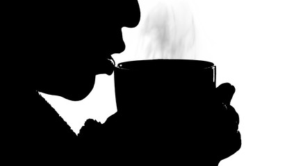 black silhouette of a girl on a white background who is drinking a hot drink from a mug