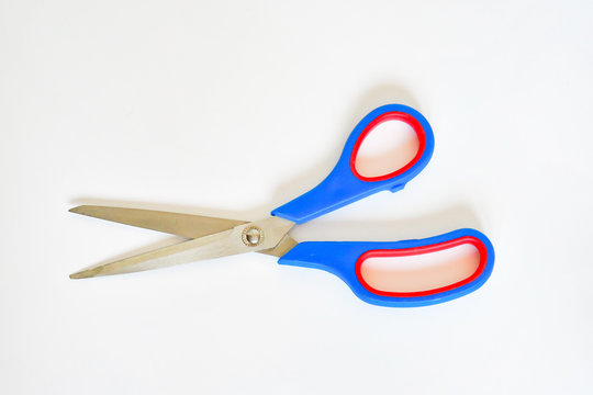 Top view cissors for cutting handcraft hobby in blue and red border on white background. Accessories sharp concept.