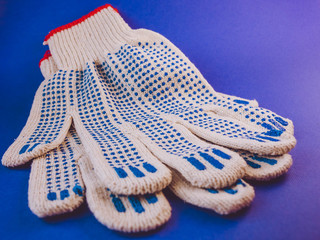 white working gloves lying on a blue background