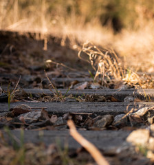 Old, rusty and dirty railway from the low / lower angle with macro focus on the stone part