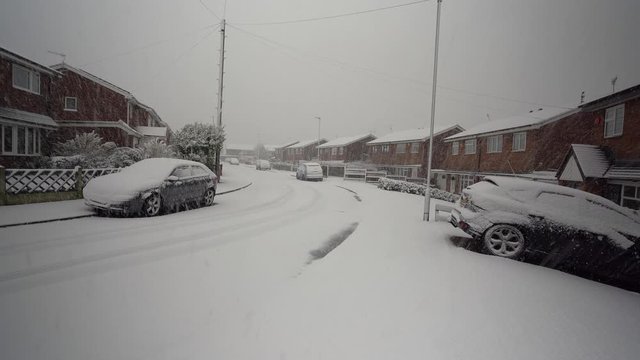A sudden snow blizzard hits the pottery town of Stoke on Trent, heavy snow fall in a short period with no warning causing dangerous driving and walking conditions, heavy snowfall in the West Midlands