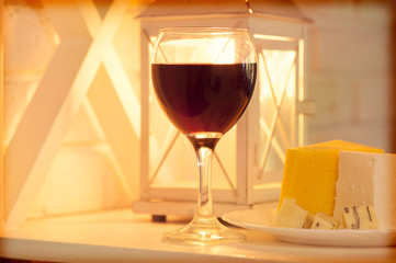 Shelf with a glass of wine and a plate of cheese