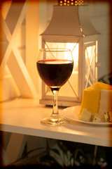 Shelf with a glass of wine and a plate of cheese