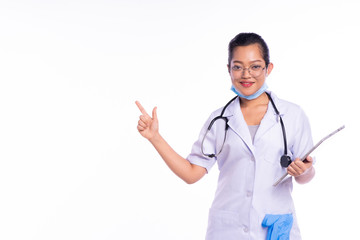 Smiling happy doctor pointing with finger on white background