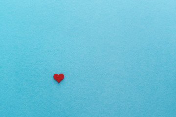  Valentine's day. Beautiful little red heart isolated on blue.
