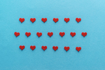  Valentine's day. Red hearts isolated on blue.